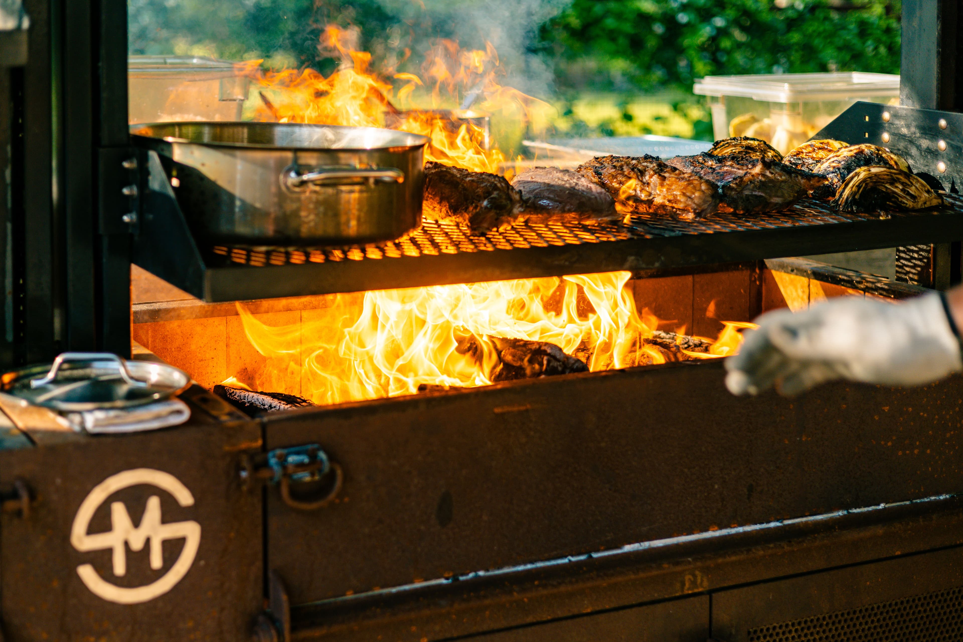 Meats cook over a live fire